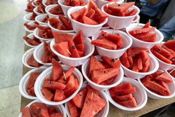 Red watermelon, cut into pieces and inserted with toothpicks.