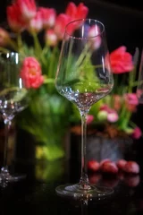 Fotobehang Eetkamer Wine glasses and flowers on the table. Selective focus. Still life floral arrangement   © O G