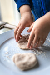 Fototapeta premium Child having fun modeling dough, authentic activity for fine motor skills development