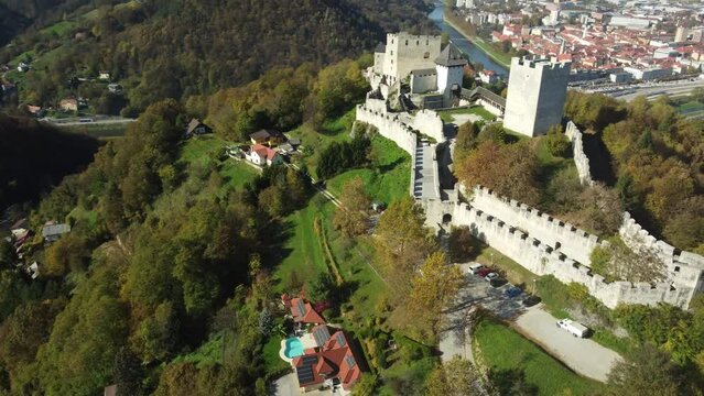 Aerial video of Celje Castle surrounded by trees on the mountain, Slovenia