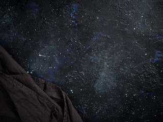 Abstract dark background, stylized as a night starry sky and a decorative towel.