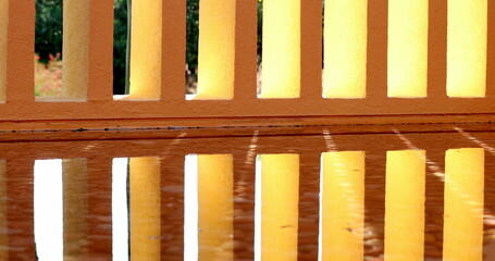 Architecture orange patterns pillars reflected on water surface