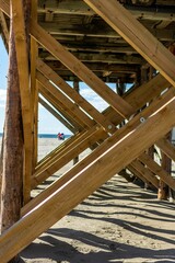 Vertical of the wooden jetty poles on the sandy beach of the North Sea in St. Peter-Ording