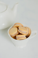 Beige biscuits on white background. Minimalist composition.
