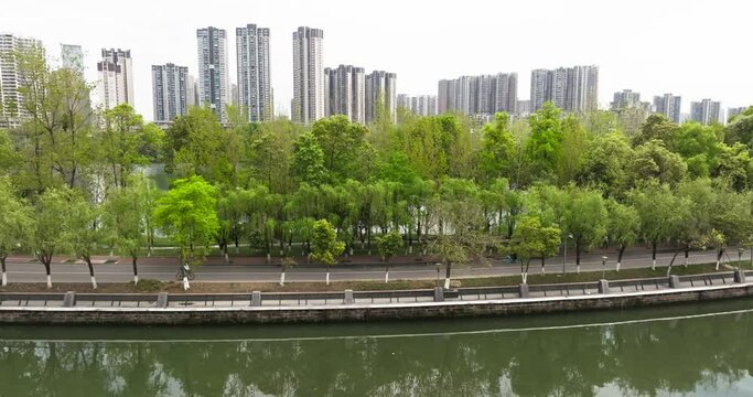 Aerial view of cars driving on the road at river side in Chengdu City park