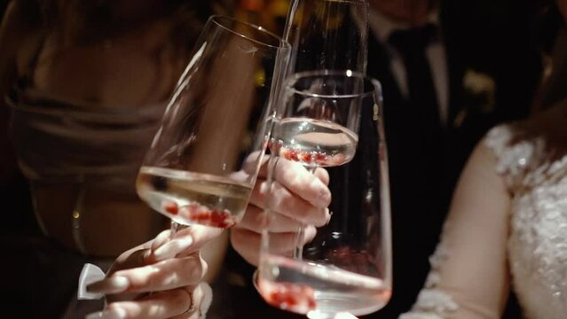 glasses with champagne sparkling wine and raspberries inside, before the start of a banquet or special event, a delicious buffet with delicious drinks for guests, celebrates birthday party