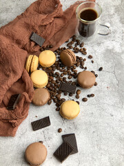Flat lay of macaroons with coffee and chocolate bars