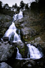 Fototapeta na wymiar Low-angle view of a water fall on a rocky mount.