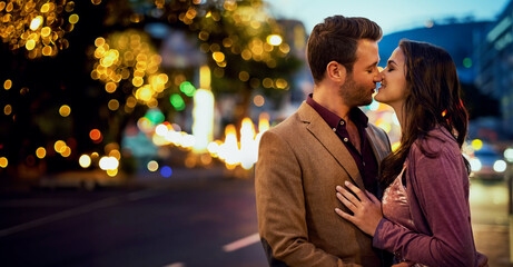 Couple, night and kiss in city for love, nose touch and bonding for romance and sweet moment....