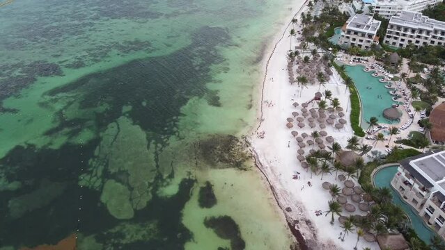 Aerial view of Akumal Bay and nearby resort buildings on the shore
