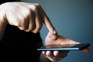 Man pointing out his finger to the blank screen of the modern smartphone