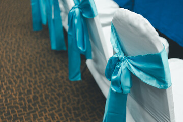 Wedding chair decorate with a blue bow. Wedding chair covers