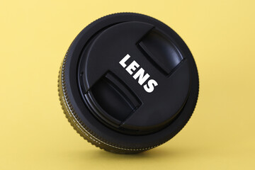 DSLR camera lens - digital camera lens 24 mm prime lens with yellow blurred background