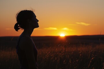 A woman stands in a field at sunset, silhouetted against the setting sun while practicing deep CJNP