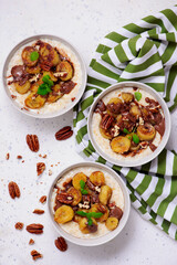 Oatmeal with caramel bananas and chocolate in to the bowl