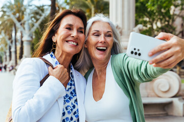 Beautiful senior women meeting outdoors in the city - 776042726