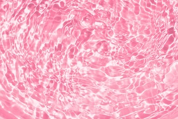Clear pink water wave texture or natural ripple background. Shadow of water on sunlight. Mockup for product, skin care cosmetics advertisement. Trendy abstract summer background