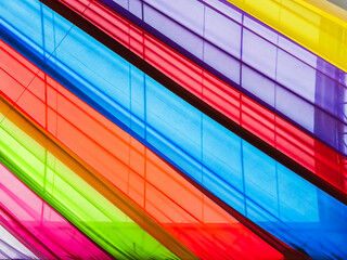 Rainbow cloth roof. Abstract image of tent roof fabricated from multicolored fabric. Colorful fabric in the festival. Multicolored backgrounds from fabrics of different colors, textured with patterns. - obrazy, fototapety, plakaty