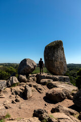 young traveling man in the mountains enjoying the great landscape between rocks and free vegetation observing 