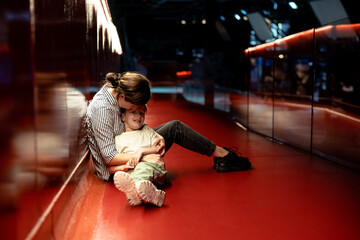  Affectionate Moment as Mother and Son Lie on Vibrant Red Floor,