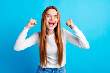 Photo portrait of attractive young woman raise fists winning dressed stylish white clothes isolated...