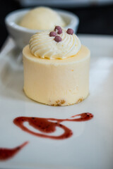 Round cheesecake dessert with raspberry and shavings