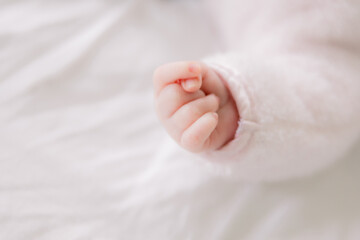 Close-up of a sweet newborn baby's hands in a fist 