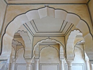 Architectural columns in Amber Fort, Jaipur, showcasing intricate designs and historical significance.