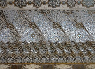 The mirror mosaic ceiling in Amer Fort showcases a mesmerizing arrangement of mirrors, resulting in a breathtaking exhibition of luminosity and reflection. 45  keywords for this title,  with comma and