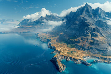 Naklejka premium A breathtaking scenery where majestic mountains meet the tranquil ocean with clouds wrapping the peaks