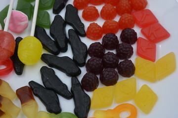 Unusual jelly candies made from natural juice. Candies in the form of a black car, raspberries,...