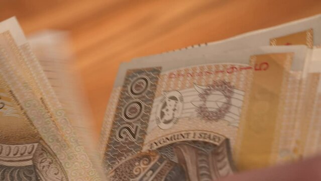 counting 200 zł bills. polish PLN currency savings