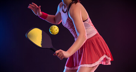 Close-up photo of Pickleball tennis player with racket and ball at open tour. Sports woman at the court. Social media template - 776097586