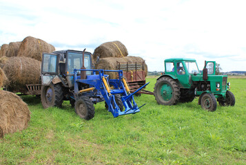 Obraz premium photo, two tractors in the field. High quality photo
