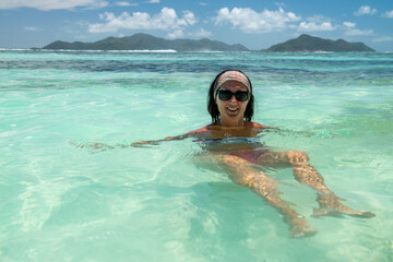 A beautiful woman enjoying life at La Digue Island in the Seychelles Archipelago