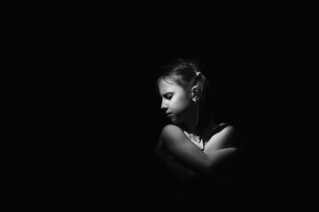 Conceptual image: lost childhood, emotional pain, and children's pain, depression and domestic violence. Portrait of sad and desperate girl. Copy space for text or design.