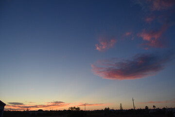 unedited relaxing pink clouds on blue summer sky