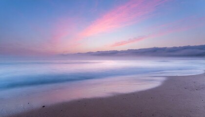 Beach in pink tones with fog coming down on horizon