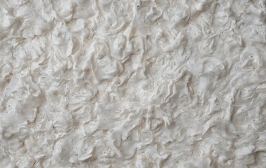 Obraz premium A closeup of white foam on beige flooring, resembling limestone texture