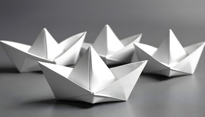 White paper boats on a gray surface