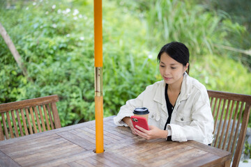 Woman use of mobile phone in outdoor cafe - 776134999