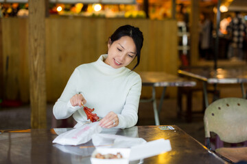 Woman enjoy her Taiwanese sausage at market - 776135554