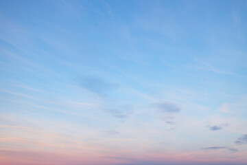 A beautiful sky tinted by the sun leaving vibrant shades of gold, pink, blue and multicolored. Clouds in the twilight evening and morning sky. Cloudy sky background in the evening and during the day.