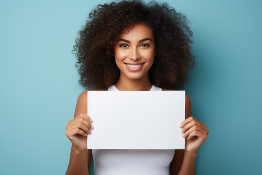 smiling woman holding a blank card, blue background, space for text, mock up