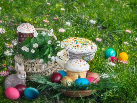 Easter chicks with basket of eggs on a lawn