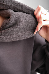 catalog shooting of a dark hoodie on a person