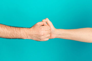 Photo of two female male arms wining loosing big thumbs war game isolated turquoise color background