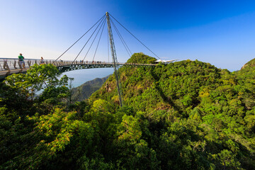 The Langkawi sky bridge over a forest with people walking on it - 776146313