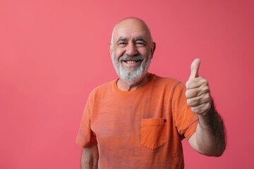 Fototapeta premium A happy smiling senior man showing thumb up Isolated on color disco background