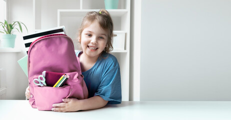 Caucasian child girl portrait with backpack.Back to school concept,school supplies.Schoolbag and...